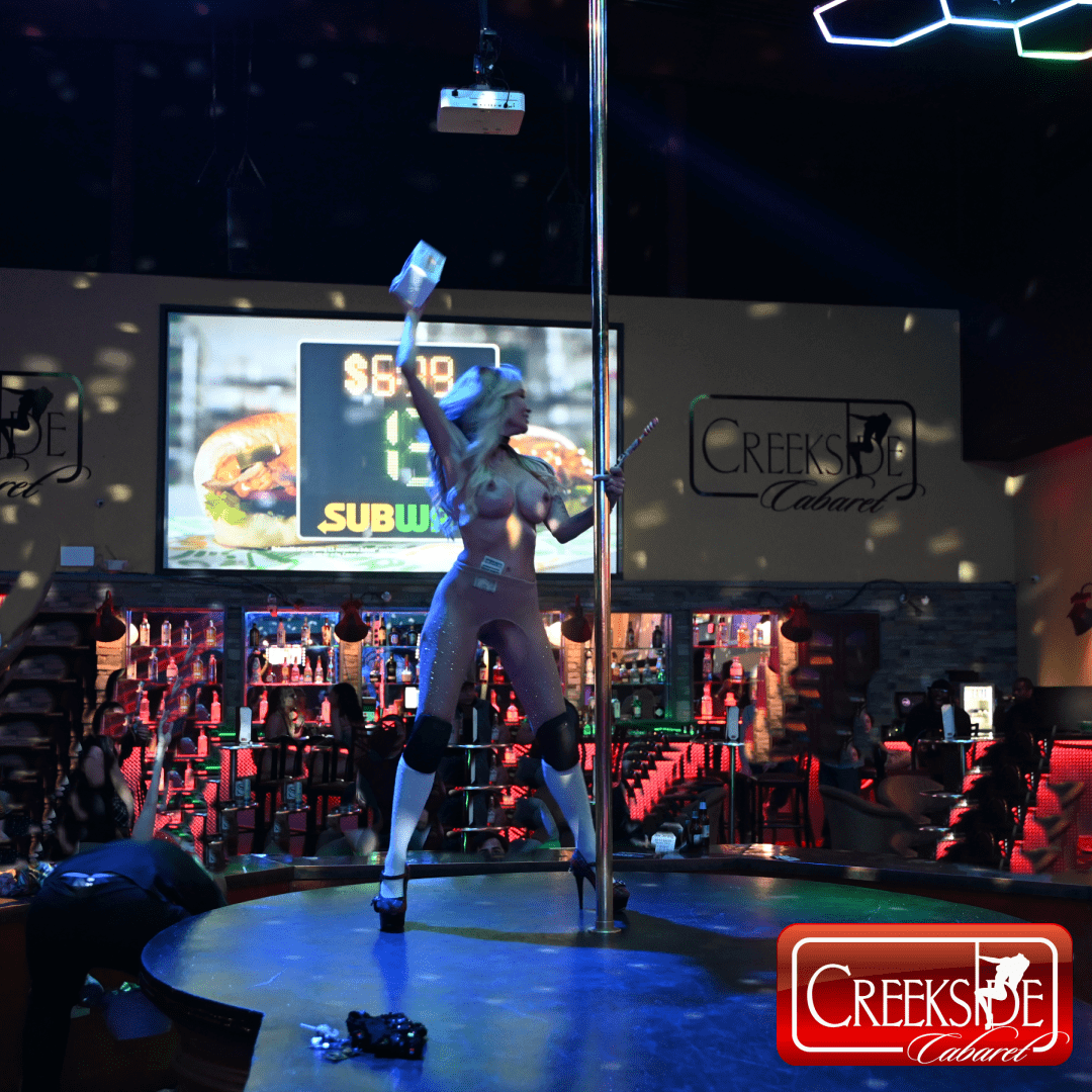 Pole dancer performing on nightclub stage