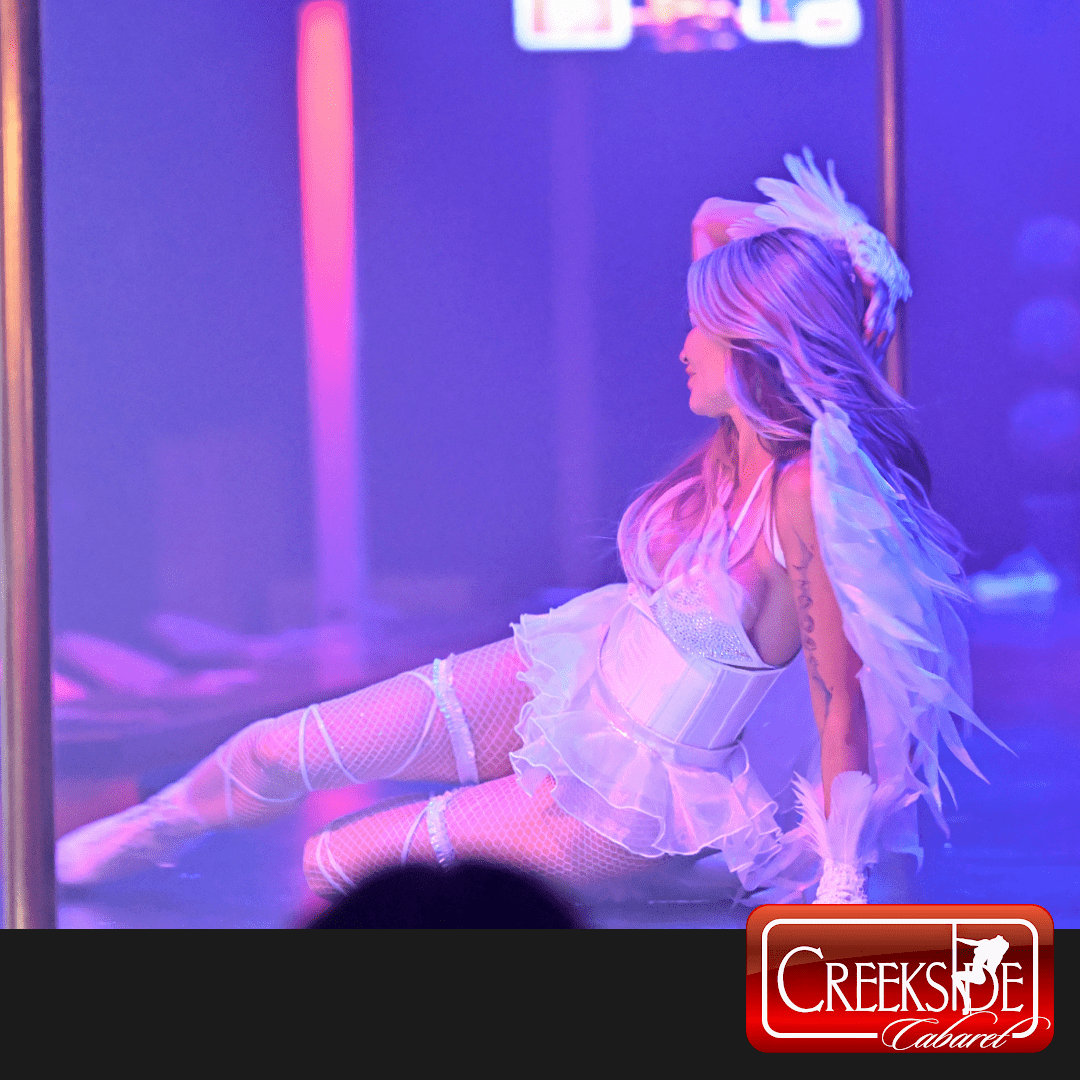 Cabaret performer in angel costume on stage